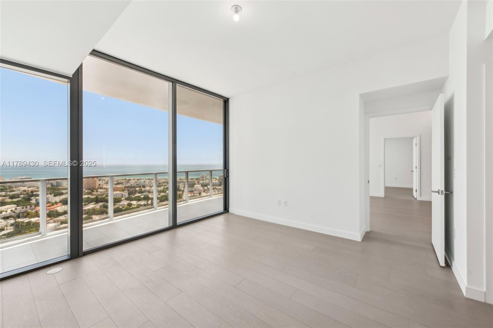 500 Alton Road, Unit 3004 Miami Beach, FL 33139 - Photo 13 of 31 an empty room with windows and city view
