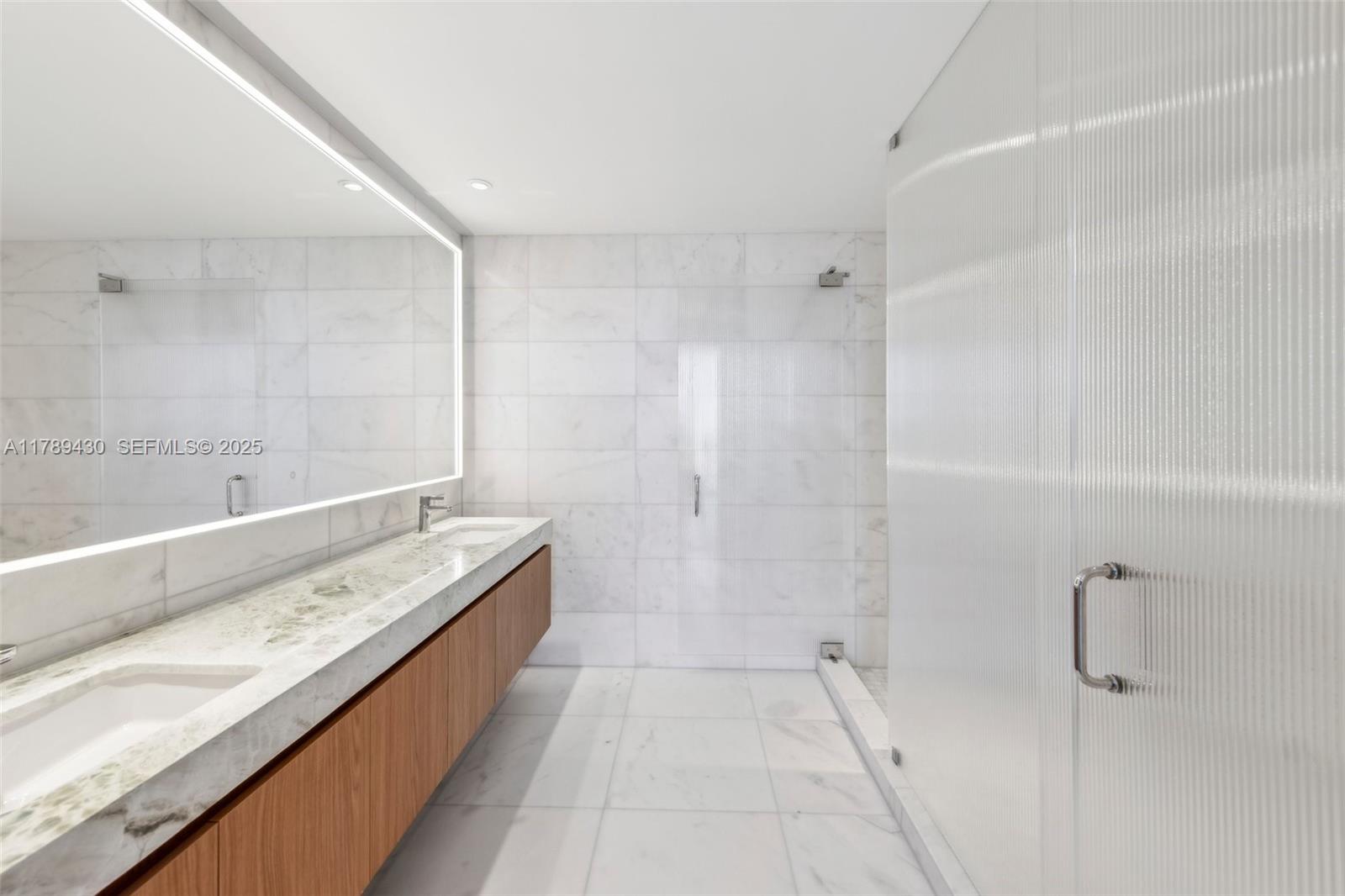 500 Alton Road, Unit 3004 Miami Beach, FL 33139 - Photo 15 of 31 a bathroom with a granite countertop bathtub shower sink and vanity