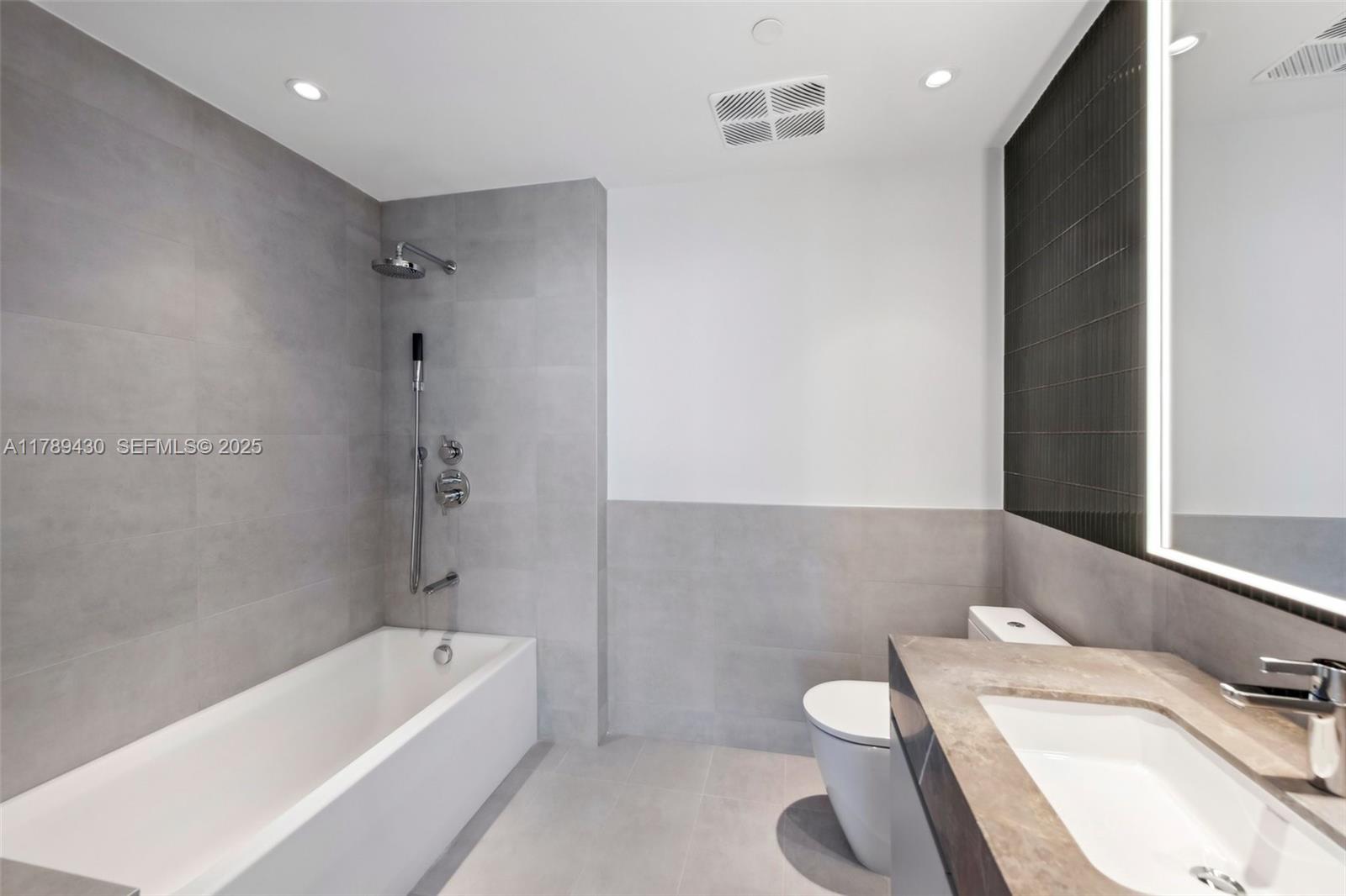 500 Alton Road, Unit 3004 Miami Beach, FL 33139 - Photo 19 of 31 a bathroom with a sink a toilet and bathtub