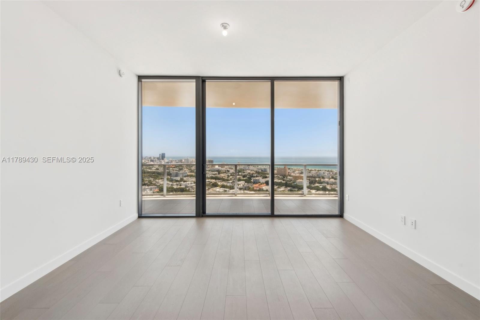 500 Alton Road, Unit 3004 Miami Beach, FL 33139 - Photo 4 of 31 a view of an empty room with a large window