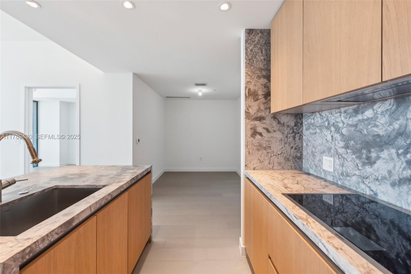 500 Alton Road, Unit 3004 Miami Beach, FL 33139 - Photo 7 of 31 a kitchen with a sink and a stove top oven