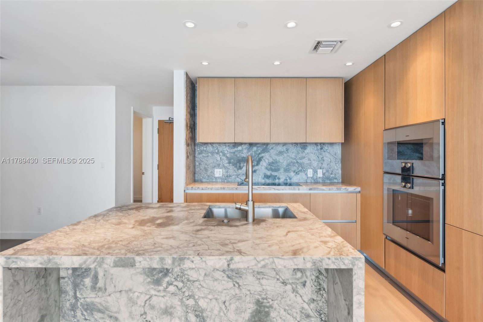 500 Alton Road, Unit 3004 Miami Beach, FL 33139 - Photo 8 of 31 a large kitchen with stainless steel appliances a large counter top