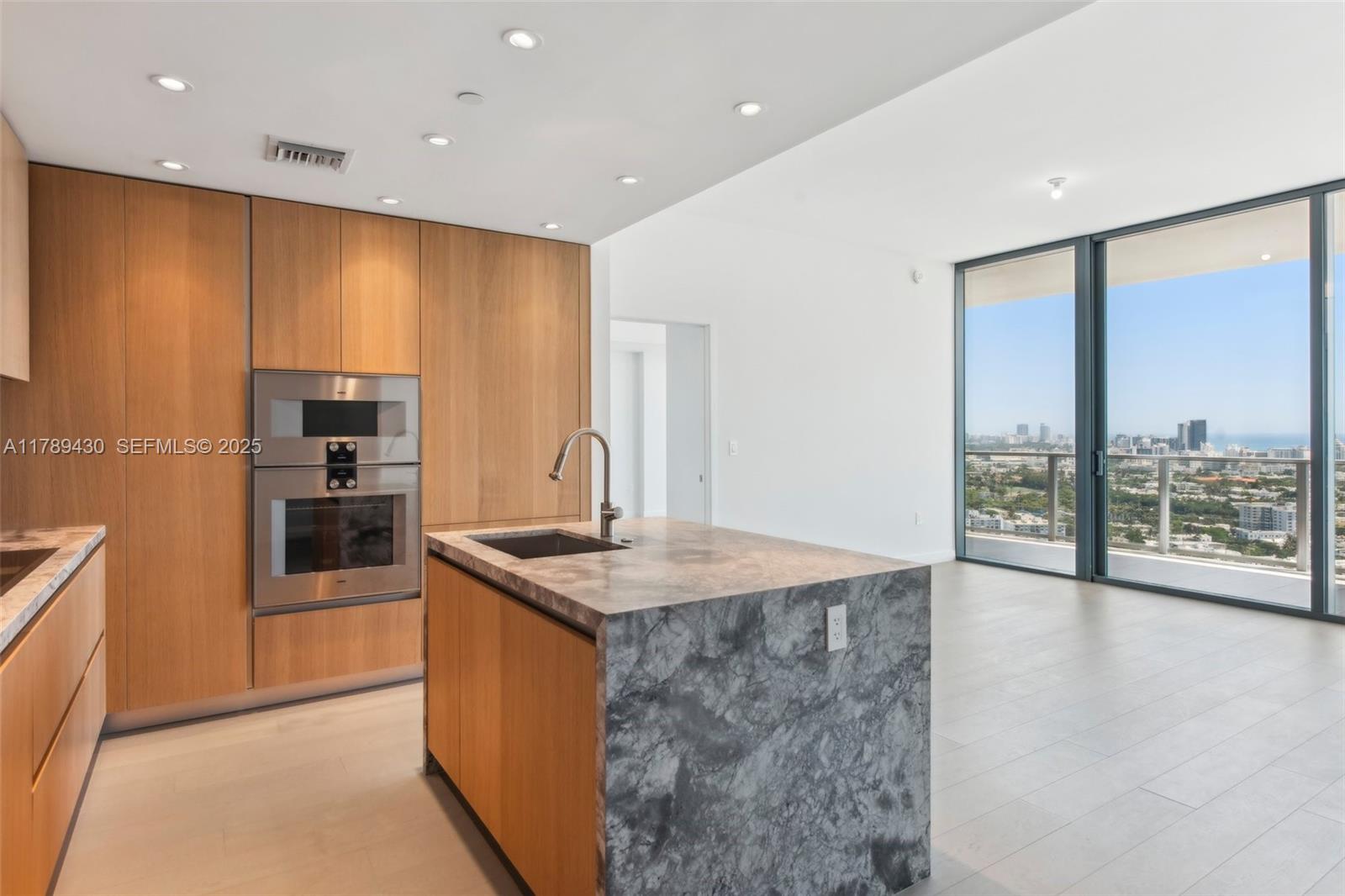 500 Alton Road, Unit 3004 Miami Beach, FL 33139 - Photo 10 of 31 a kitchen with stainless steel appliances granite countertop a sink a stove and a refrigerator
