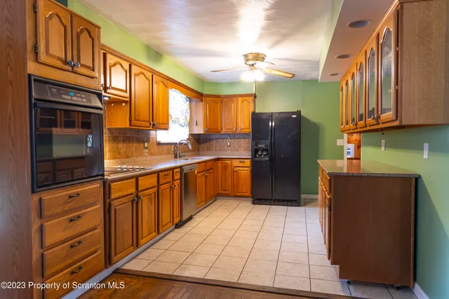 a kitchen with stainless steel appliances granite countertop a refrigerator a sink and dishwasher
