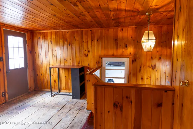 a view of a room with wooden floor and windows