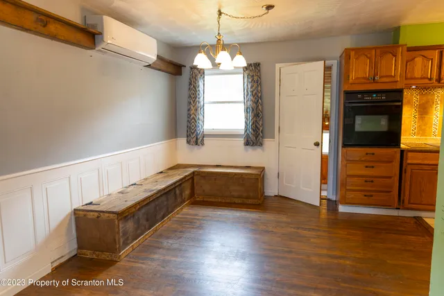 a hallway with couches and wooden floor