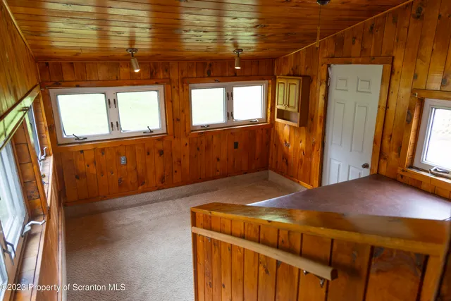 a bedroom with a bed and wooden floors