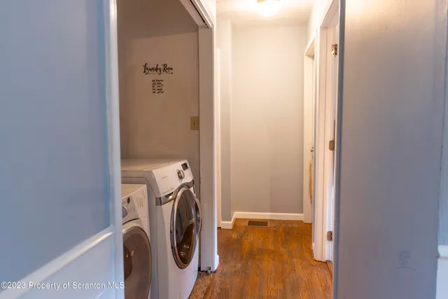 a view of walk in closet with clothes