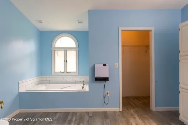 a bath tub sitting in a bathroom next to a window