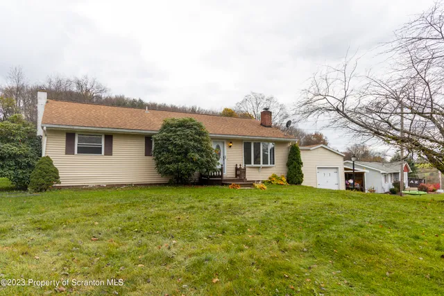 a big house with a big yard and large trees