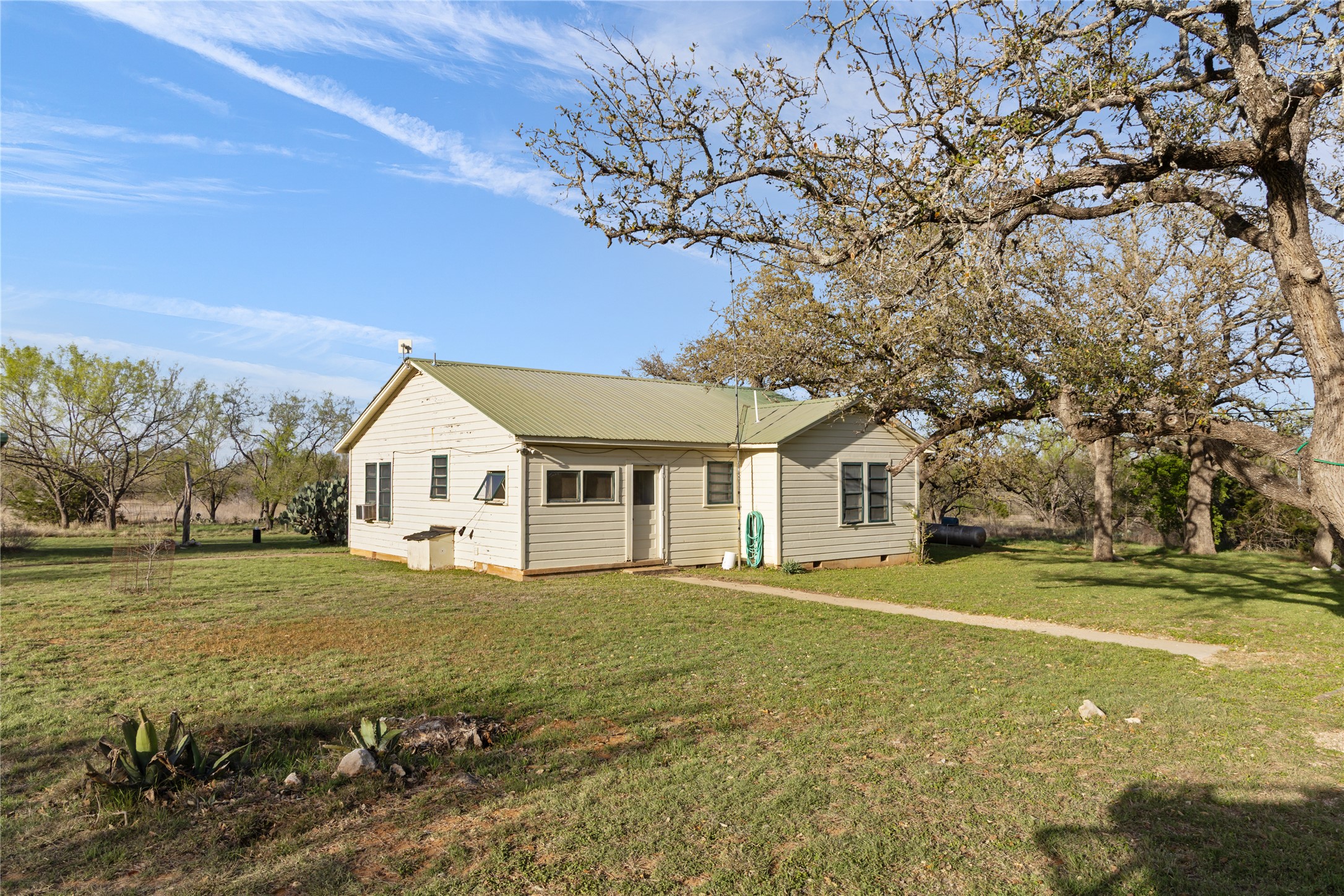 892 Baird Ranch Road Johnson City, TX 78636 - Photo 12 of 39 a front view of a house with a yard