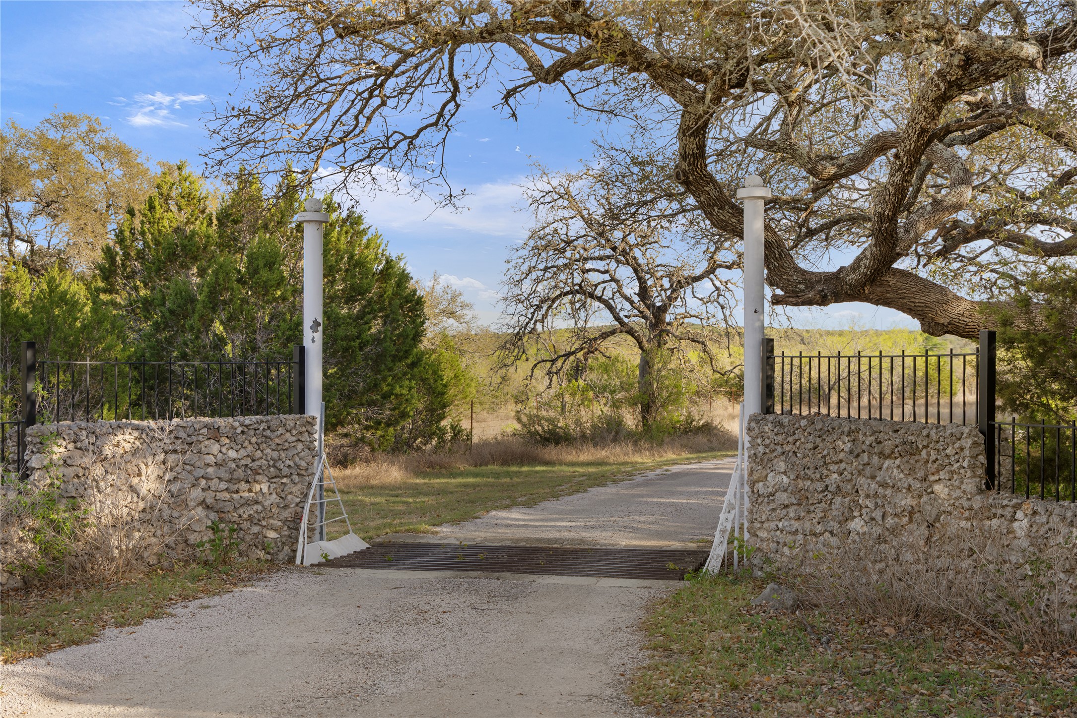 892 Baird Ranch Road Johnson City, TX 78636 - Photo 13 of 39 a view of a yard with large tree and wooden fence