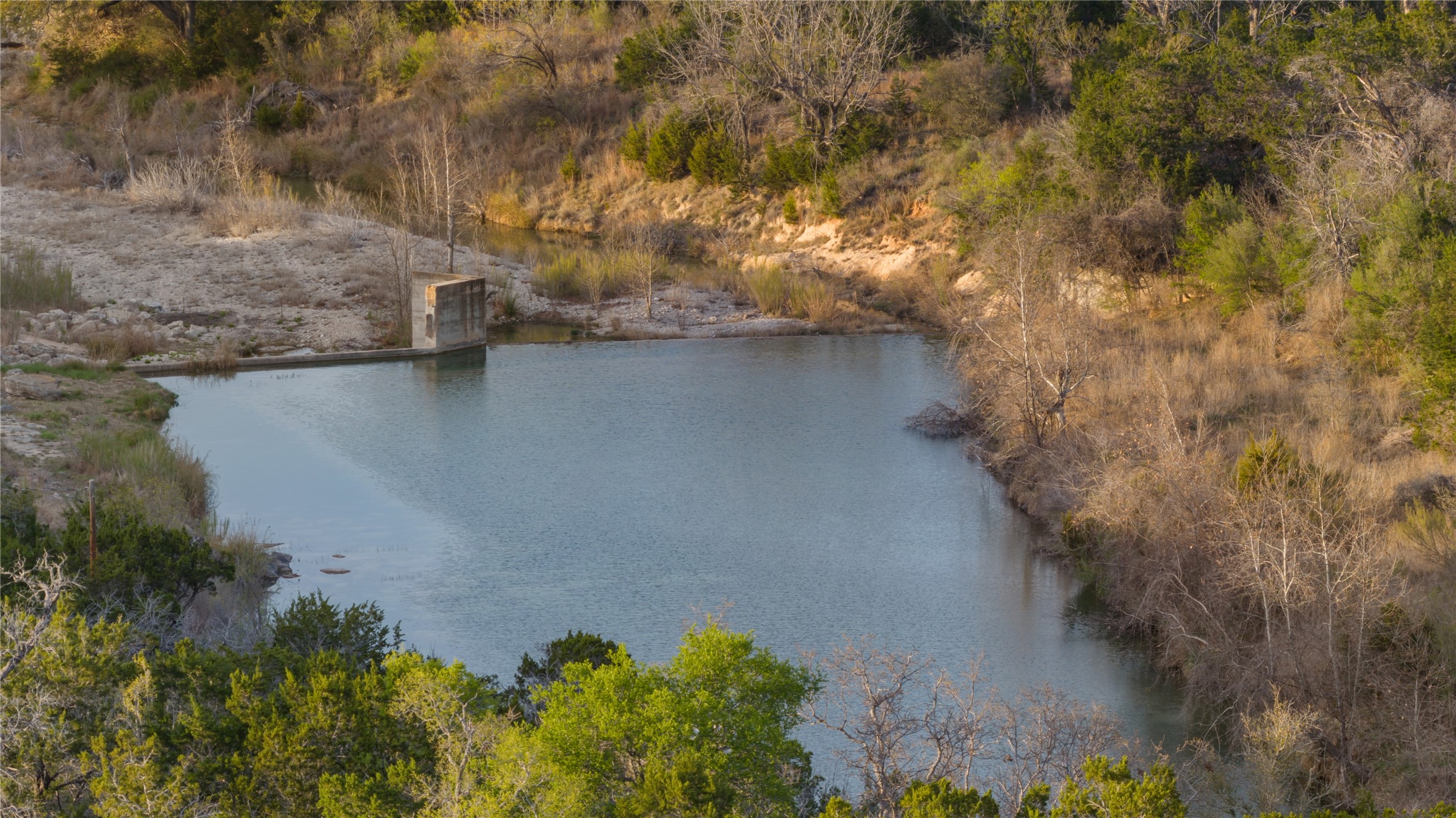 892 Baird Ranch Road Johnson City, TX 78636 - Photo 34 of 39 a view of a lake in a forest