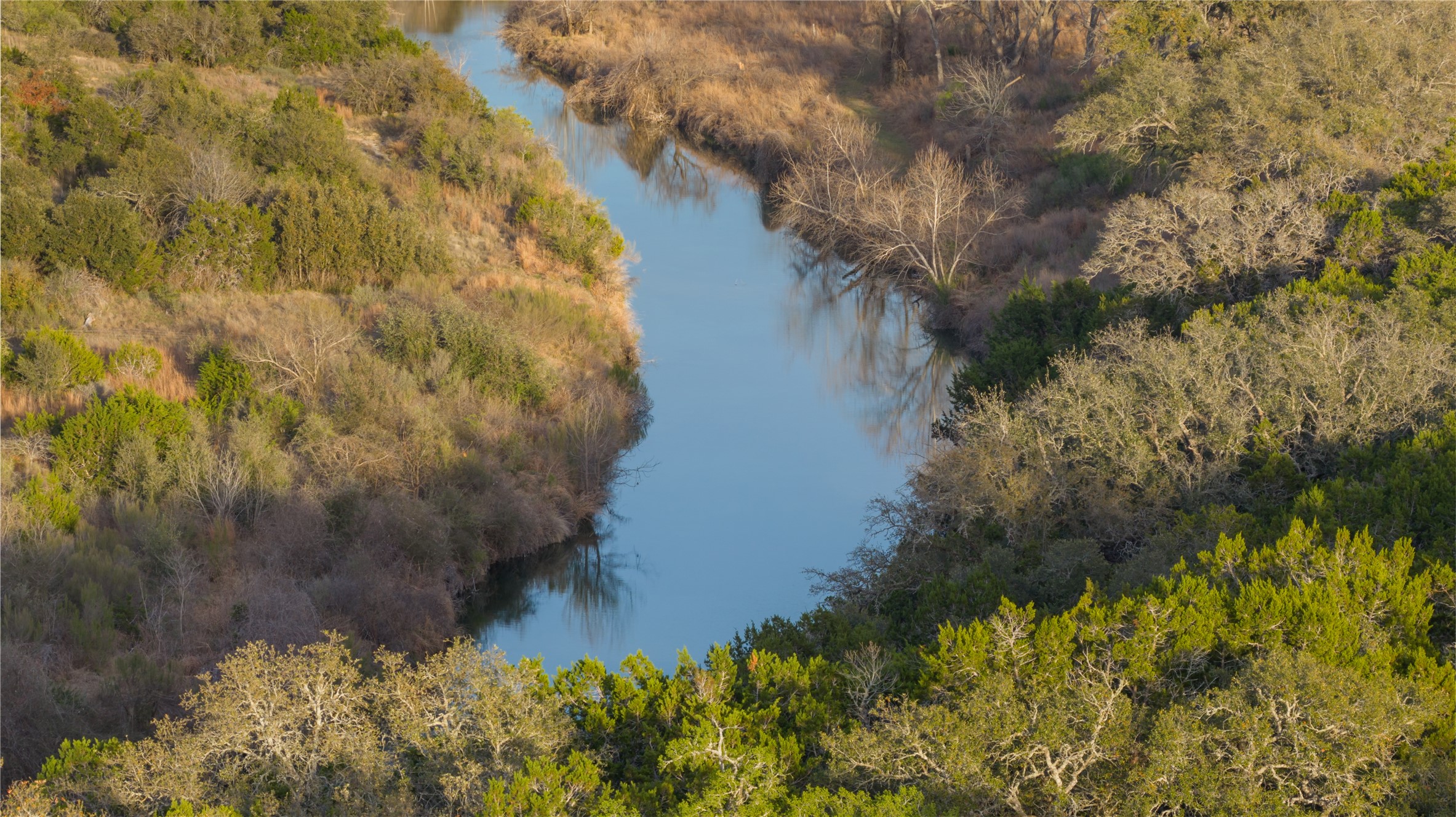 892 Baird Ranch Road Johnson City, TX 78636 - Photo 35 of 39 a view of a lake with a yard