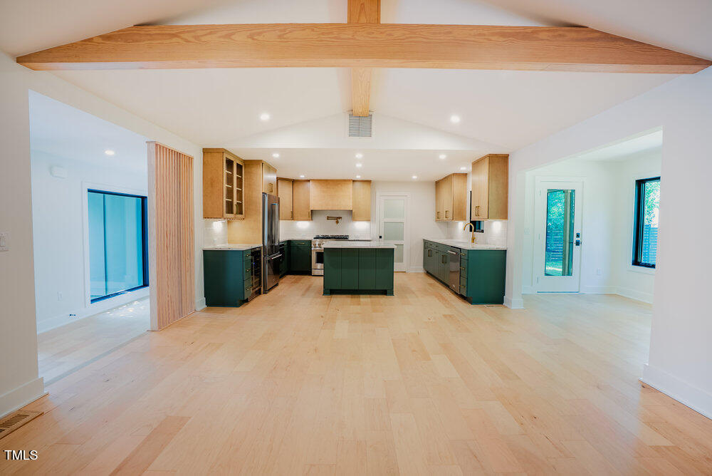 2129 Ridge Road Raleigh, NC 27607 - Photo 11 of 56 a large white kitchen with a refrigerator a stove top oven a sink and dishwasher