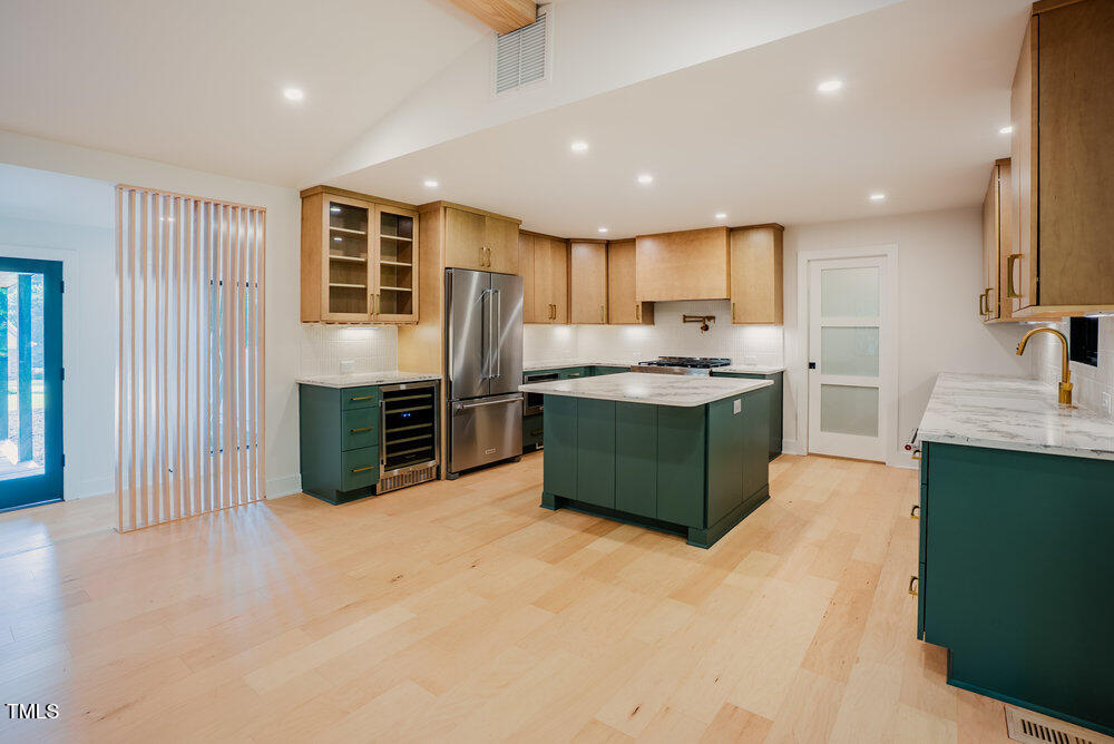 2129 Ridge Road Raleigh, NC 27607 - Photo 12 of 56 a kitchen with stainless steel appliances granite countertop a sink stove and refrigerator