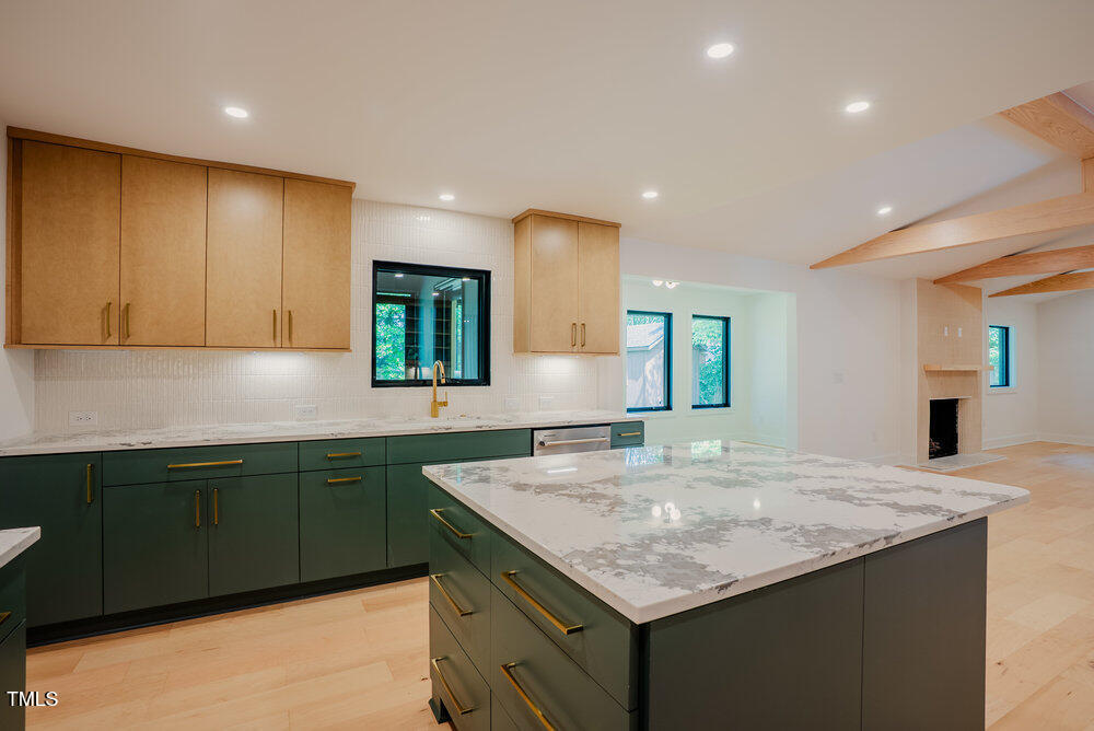 2129 Ridge Road Raleigh, NC 27607 - Photo 14 of 56 a kitchen with sink cabinets and wooden floor
