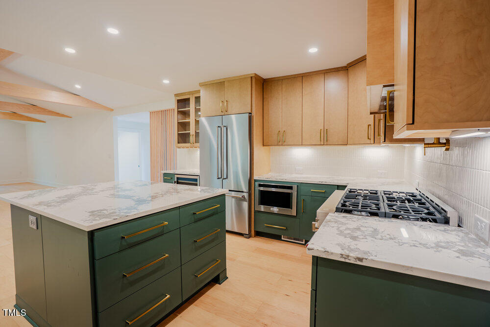 2129 Ridge Road Raleigh, NC 27607 - Photo 15 of 56 a kitchen with a sink stove and refrigerator