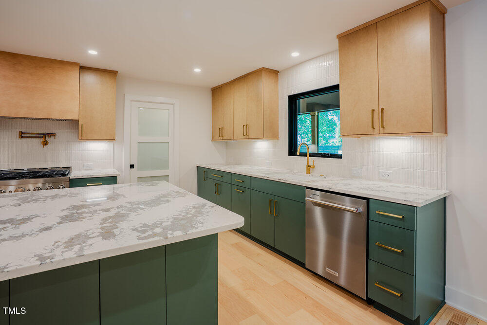 2129 Ridge Road Raleigh, NC 27607 - Photo 16 of 56 a kitchen with stainless steel appliances granite countertop a sink stove and cabinets