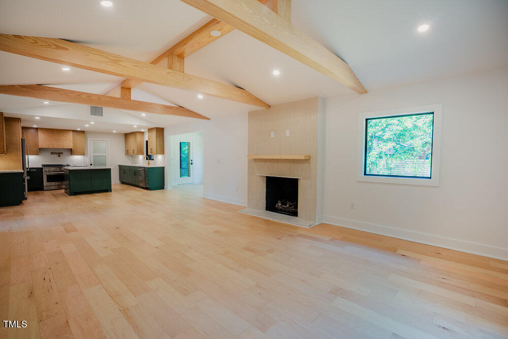 2129 Ridge Road Raleigh, NC 27607 - Photo 17 of 56 a view of an empty room with a fireplace and a window