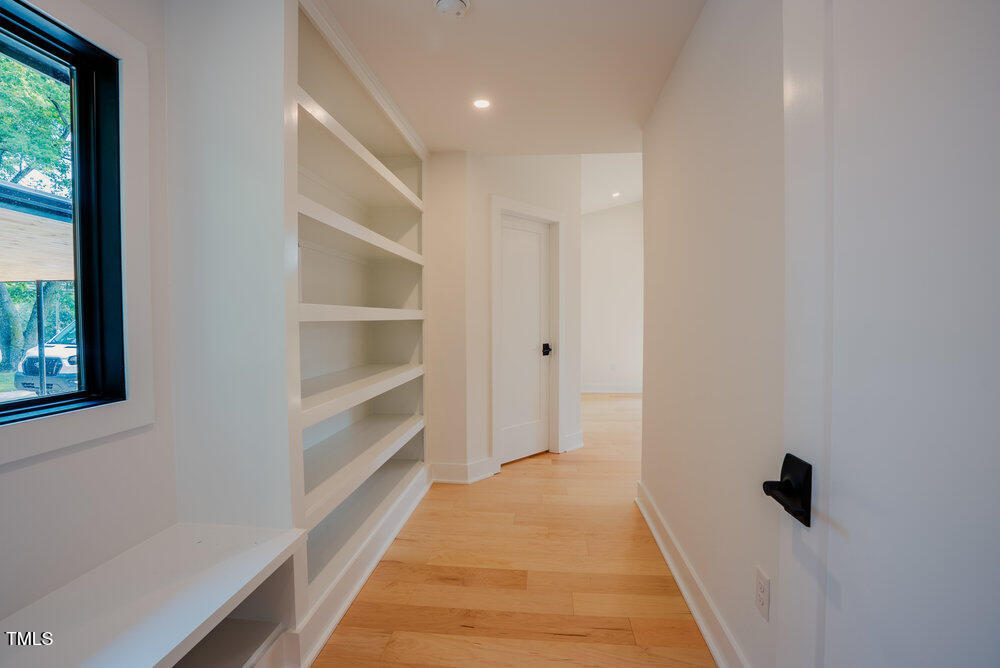 2129 Ridge Road Raleigh, NC 27607 - Photo 24 of 56 a view of a hallway with wooden floor and a window