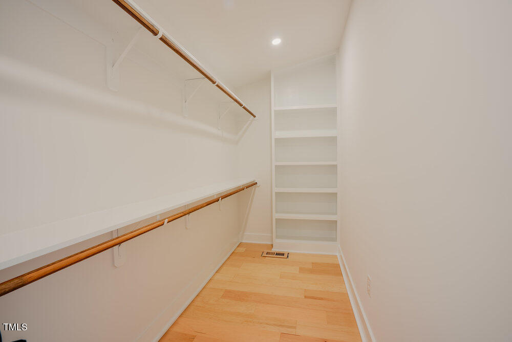 2129 Ridge Road Raleigh, NC 27607 - Photo 27 of 56 a walk in closet with wooden floor