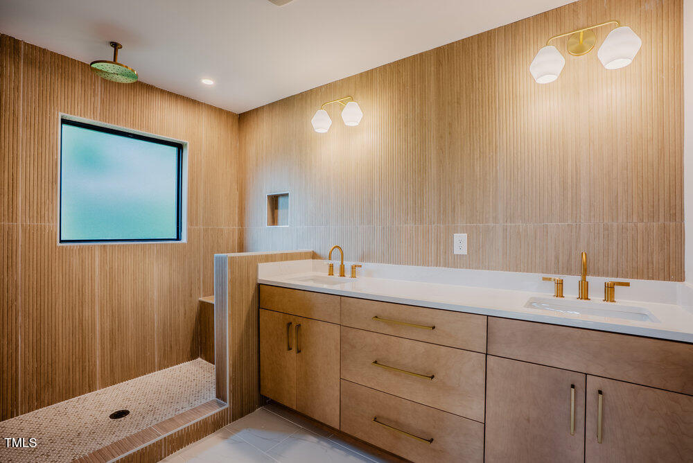2129 Ridge Road Raleigh, NC 27607 - Photo 28 of 56 a bathroom with a double vanity sink and a mirror