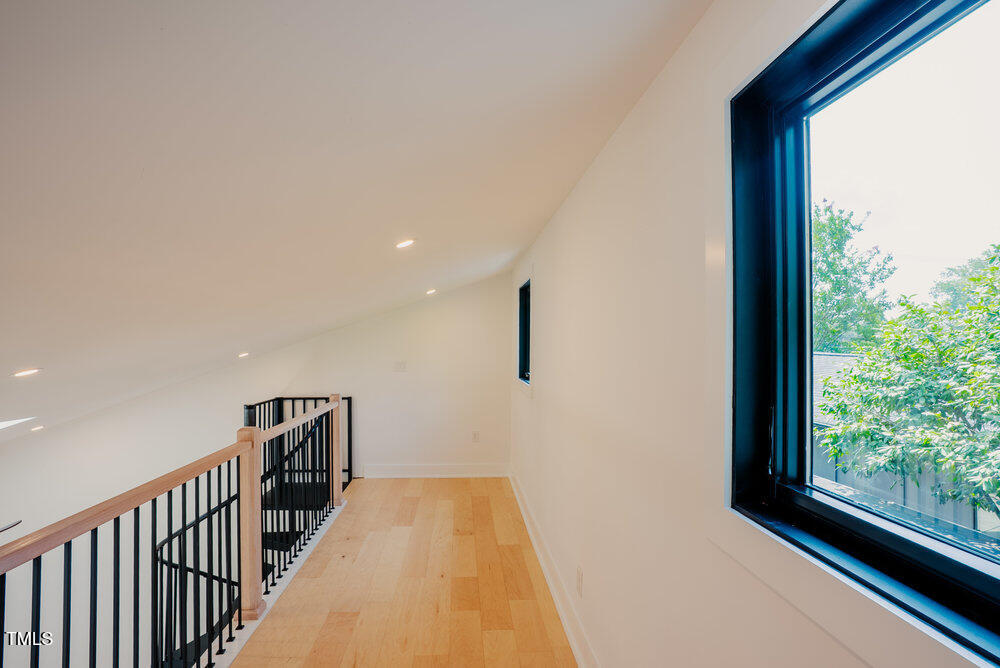 2129 Ridge Road Raleigh, NC 27607 - Photo 38 of 56 a view of a hallway with wooden floor and staircase