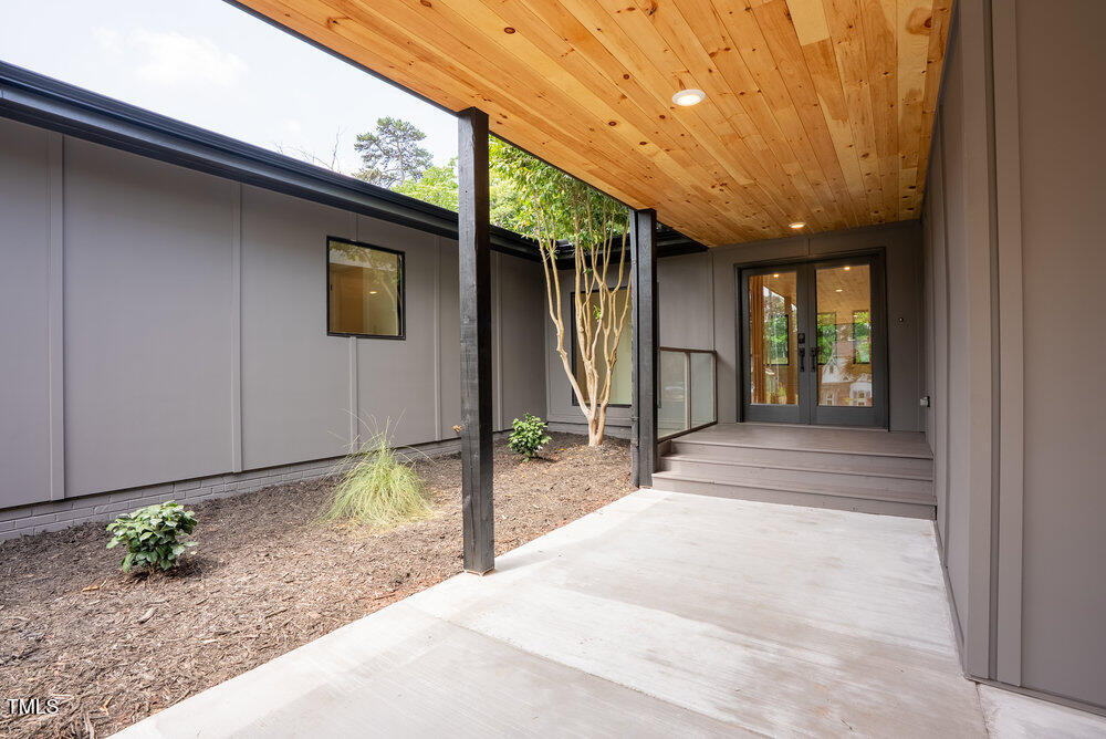 2129 Ridge Road Raleigh, NC 27607 - Photo 5 of 56 a view of a house with porch and wooden floor