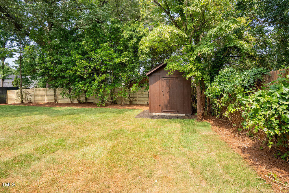 2129 Ridge Road Raleigh, NC 27607 - Photo 53 of 56 a house with trees in the background