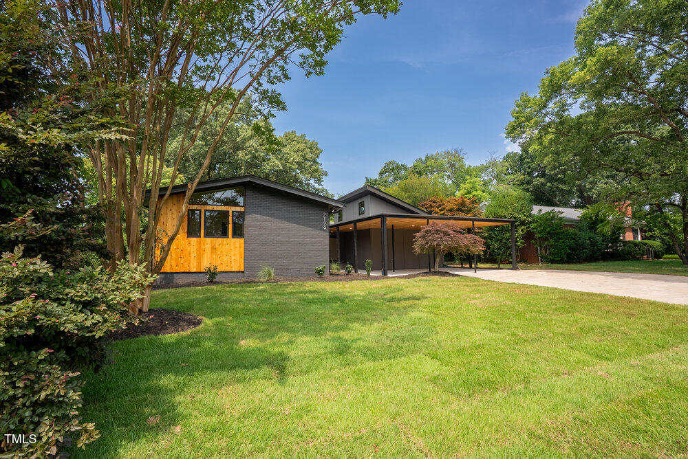 2129 Ridge Road Raleigh, NC 27607 - Photo 55 of 56 a backyard of a house with plants and large trees