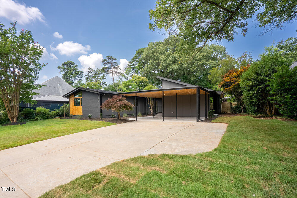 2129 Ridge Road Raleigh, NC 27607 - Photo 56 of 56 a front view of a house with a yard and garage