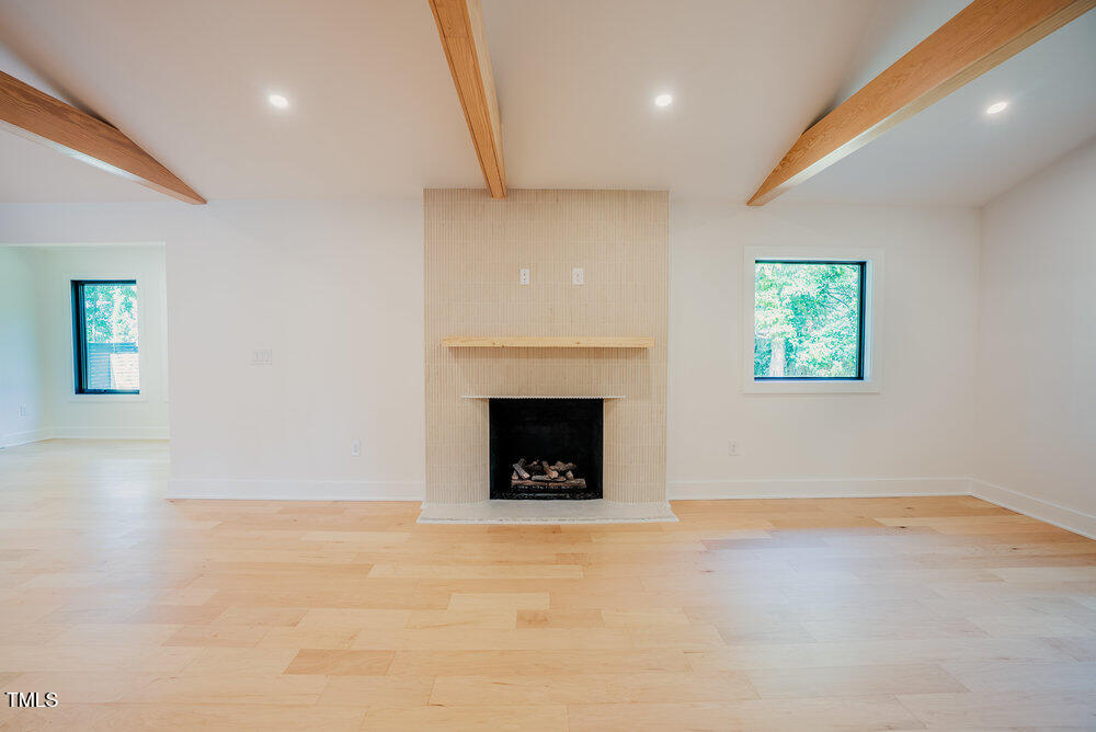 2129 Ridge Road Raleigh, NC 27607 - Photo 10 of 56 an empty room with a fireplace and window
