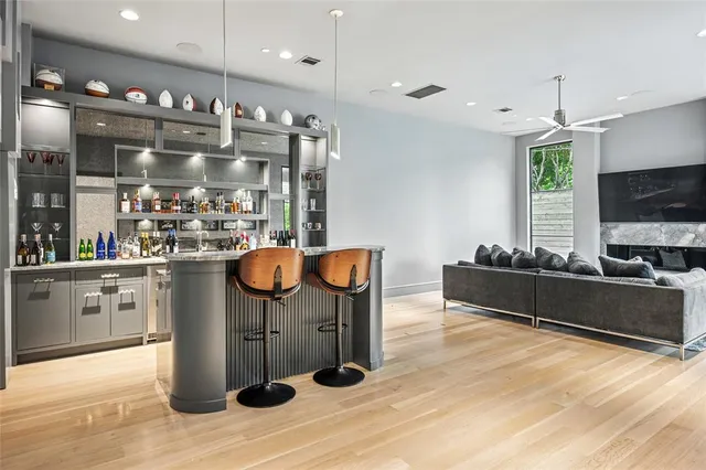a living room with stainless steel appliances kitchen island granite countertop furniture and a flat screen tv