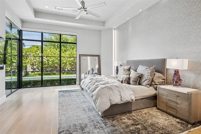 a spacious bedroom with a bed and a large window