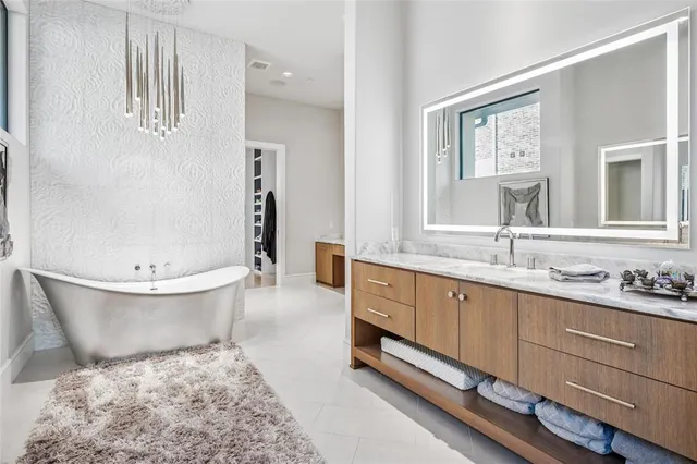 a bathroom with a tub sink and mirror