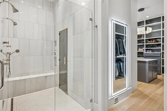 a bathroom with a shower and a room