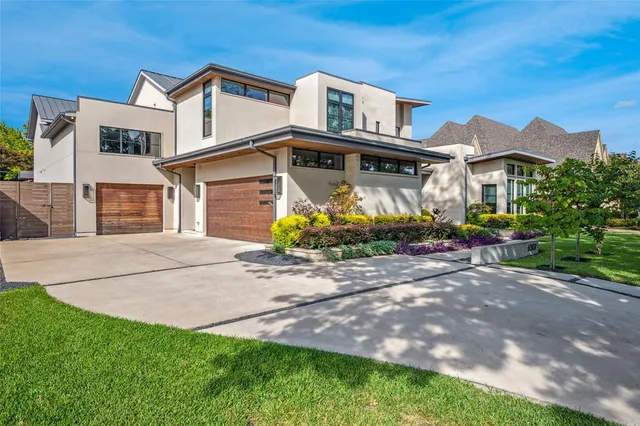 a front view of a house with a yard and a garage