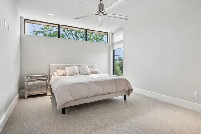 a bedroom with a bed and ceiling fan