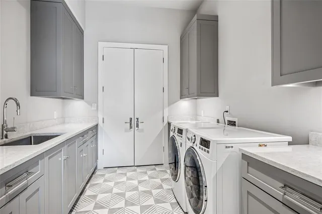 a utility room with sink dryer and washer