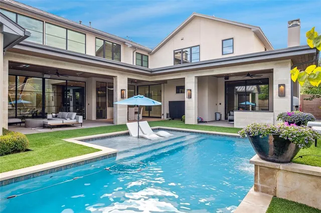 a view of an house with swimming pool and porch
