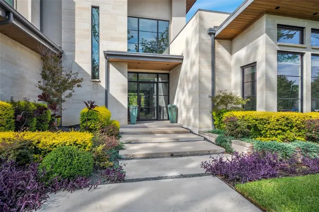 a view of a house with potted plants