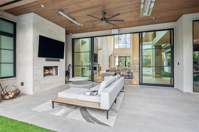 a living room with furniture tv and a fireplace