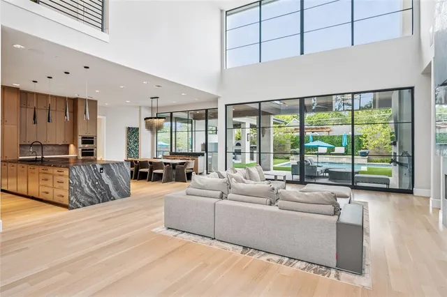 a living room with furniture and large windows