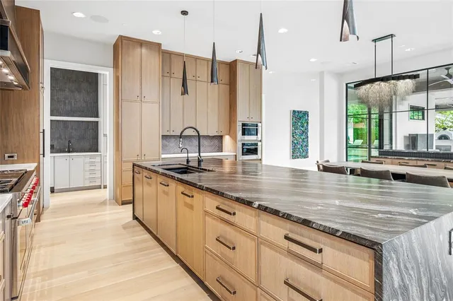 an open kitchen with granite countertop a sink and a stove