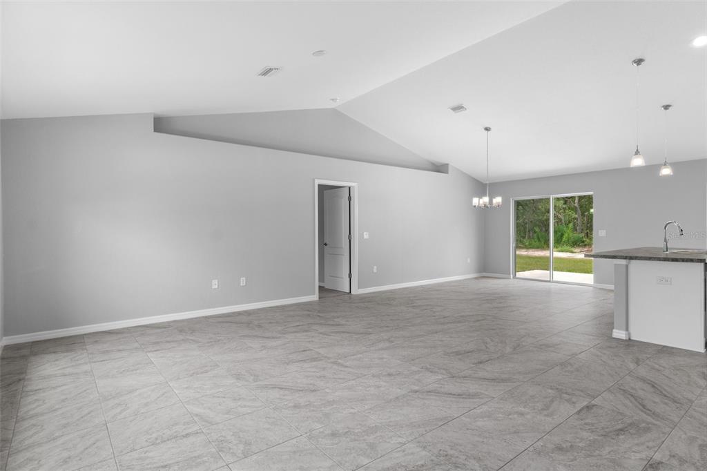 16375 Kakawi Road Brooksville, FL 34614 - Photo 6 of 30 wooden floor in an empty room with a window