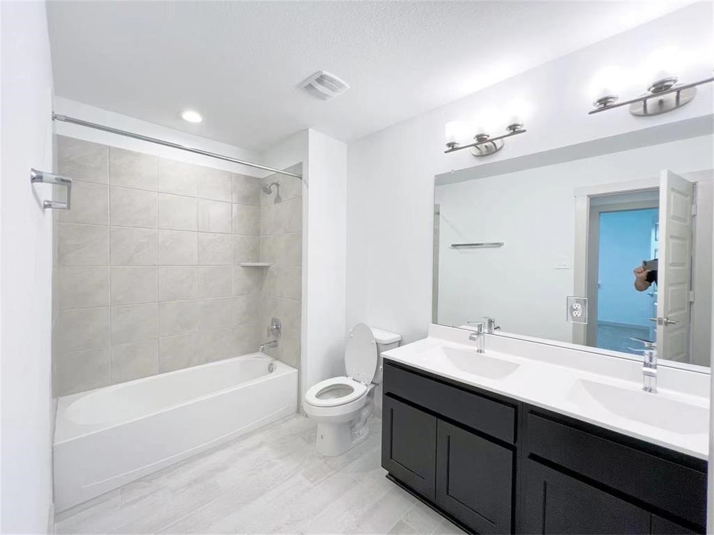28310 Hazel Trail Katy, TX 77494 - Photo 12 of 26 a bathroom with a double vanity sink toilet mirror and bathtub