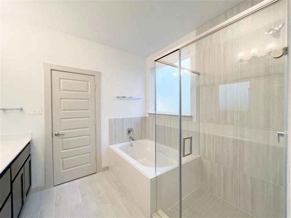 28310 Hazel Trail Katy, TX 77494 - Photo 13 of 26 a bathroom with a bathtub and a shower