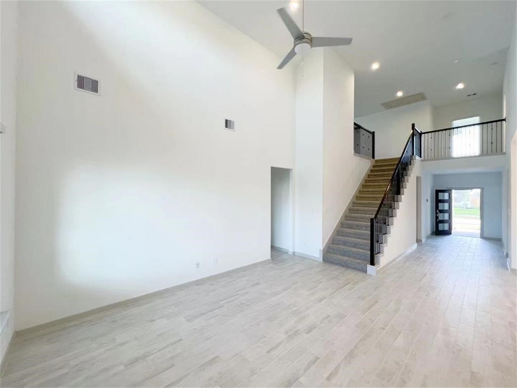 28310 Hazel Trail Katy, TX 77494 - Photo 9 of 26 a view of an empty room with wooden floor and stairs