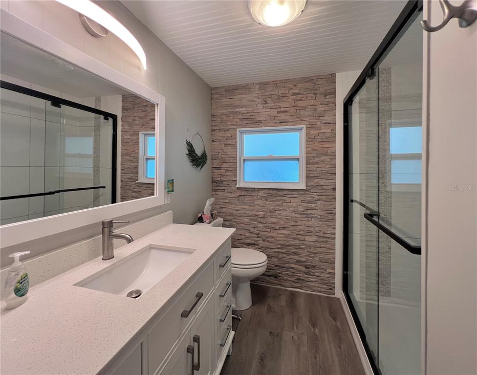 1100 South Belcher Road, Unit 772 Largo, FL 33771 - Photo 30 of 84 a bathroom with a sink a toilet and mirror